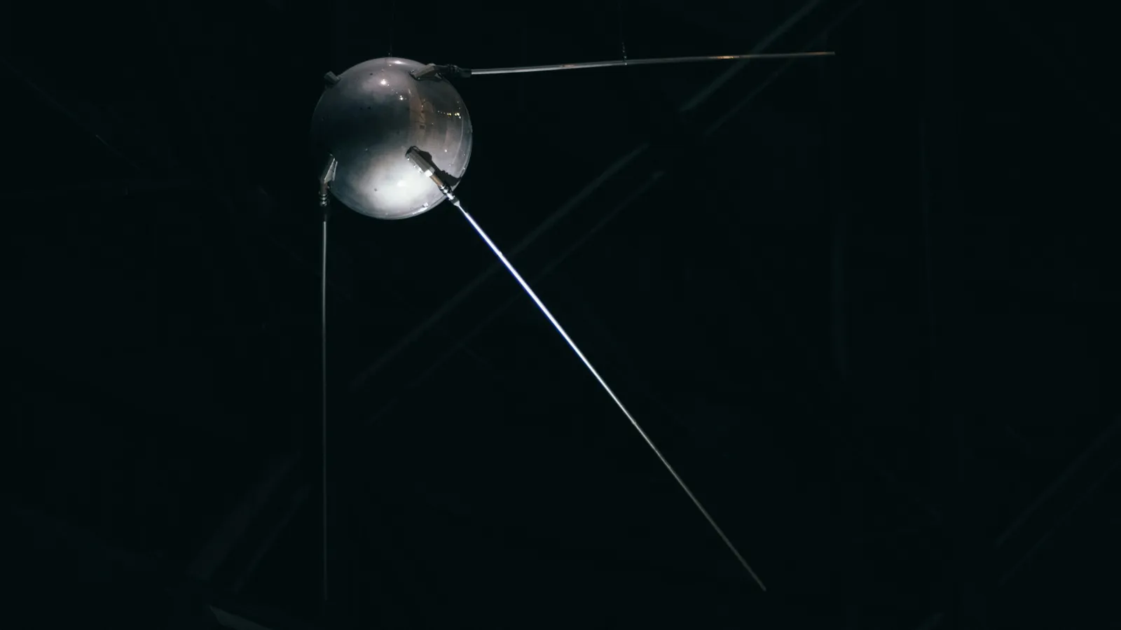 A model of a small spherical satellite with long antennas