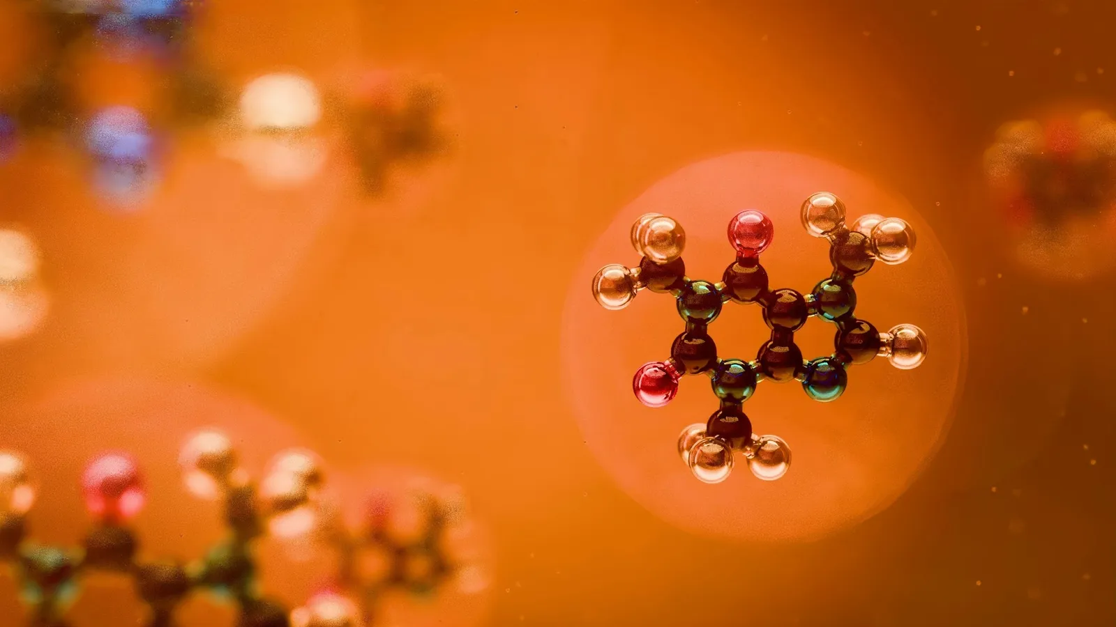 A molecular model highlighted against a warm orange background