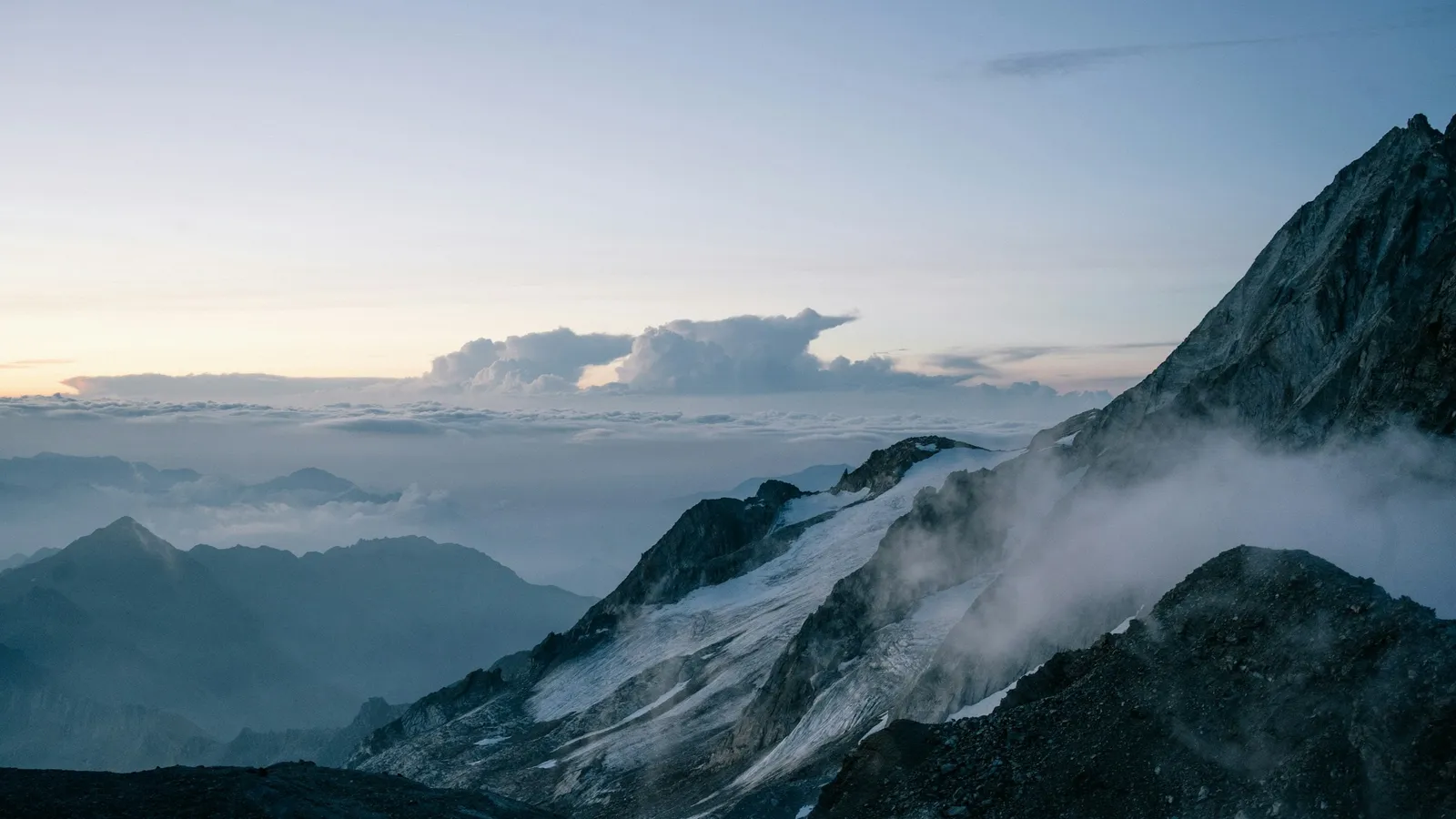 A mountain peak rising above the clouds