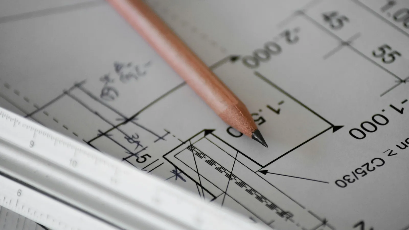 A pencil drawing lines on graph paper