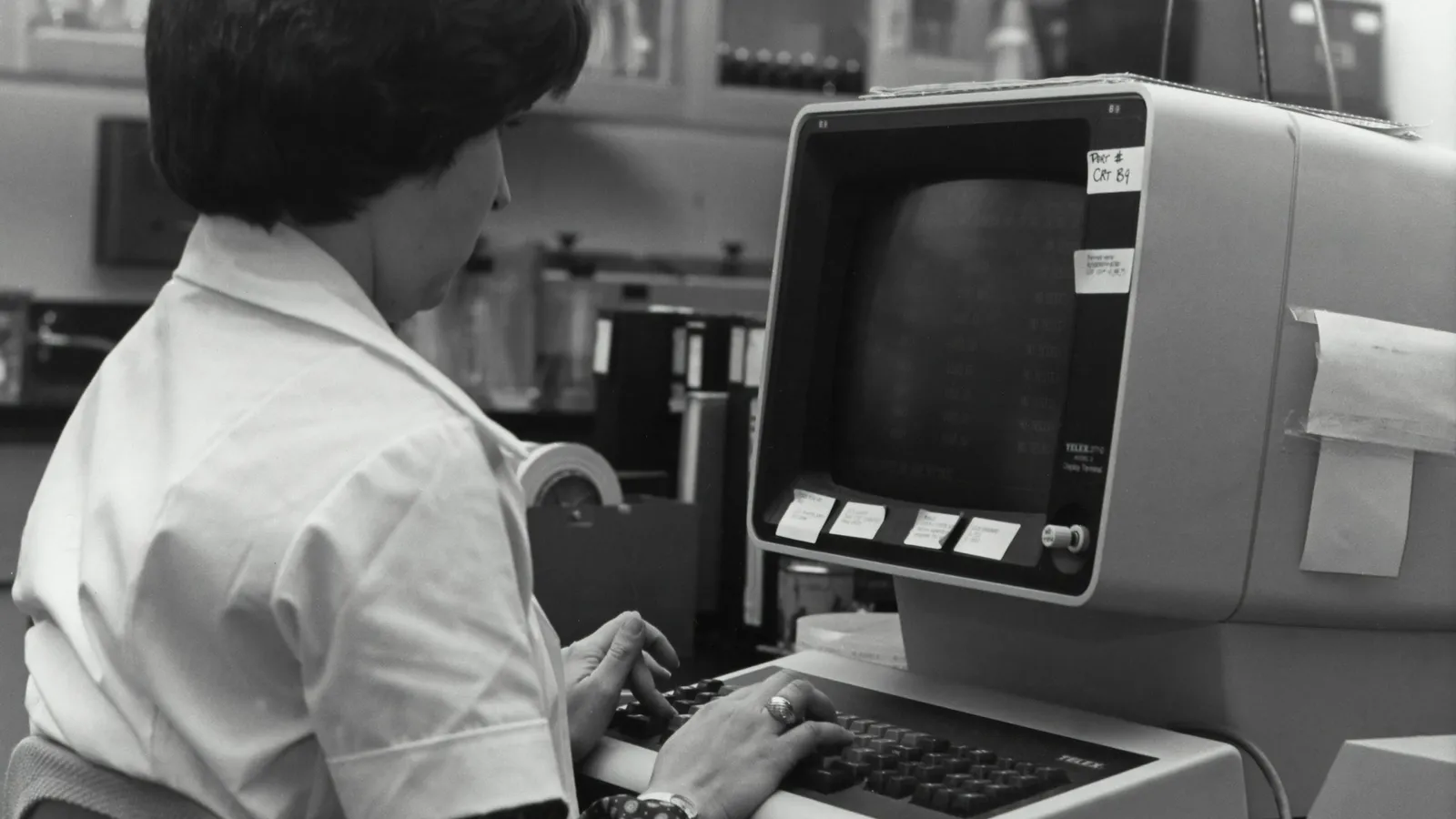 A person working at an early computer terminal