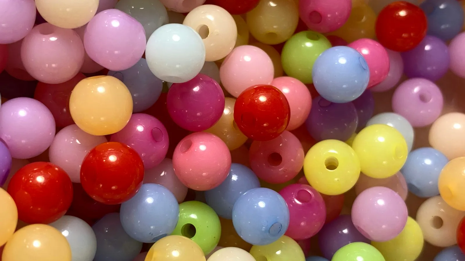 A pile of colourful round plastic beads