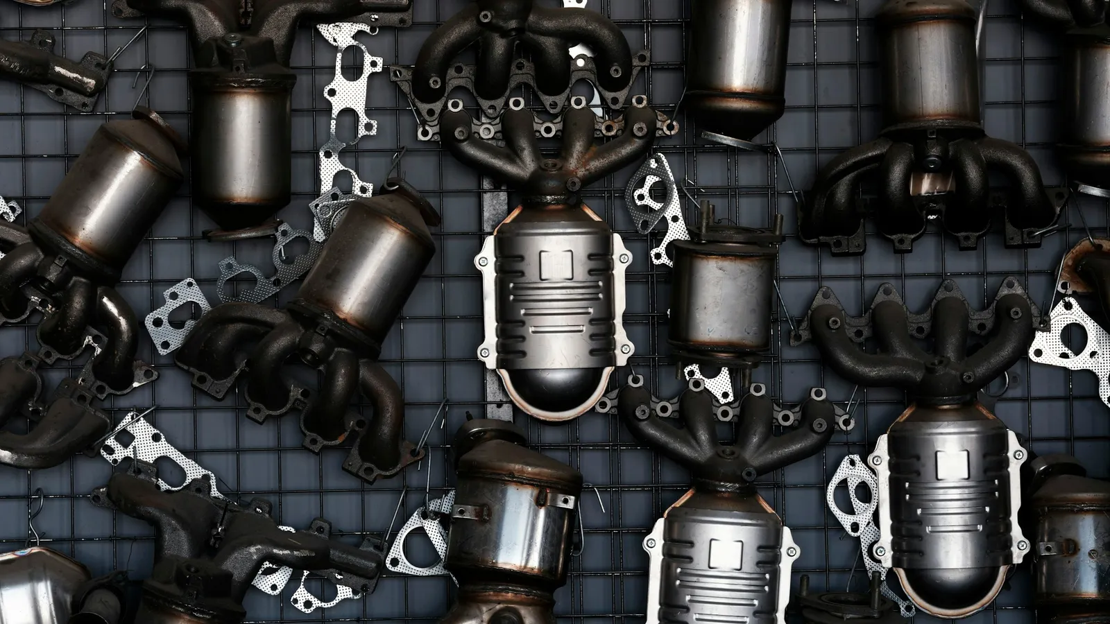 A pile of old metal car exhaust parts