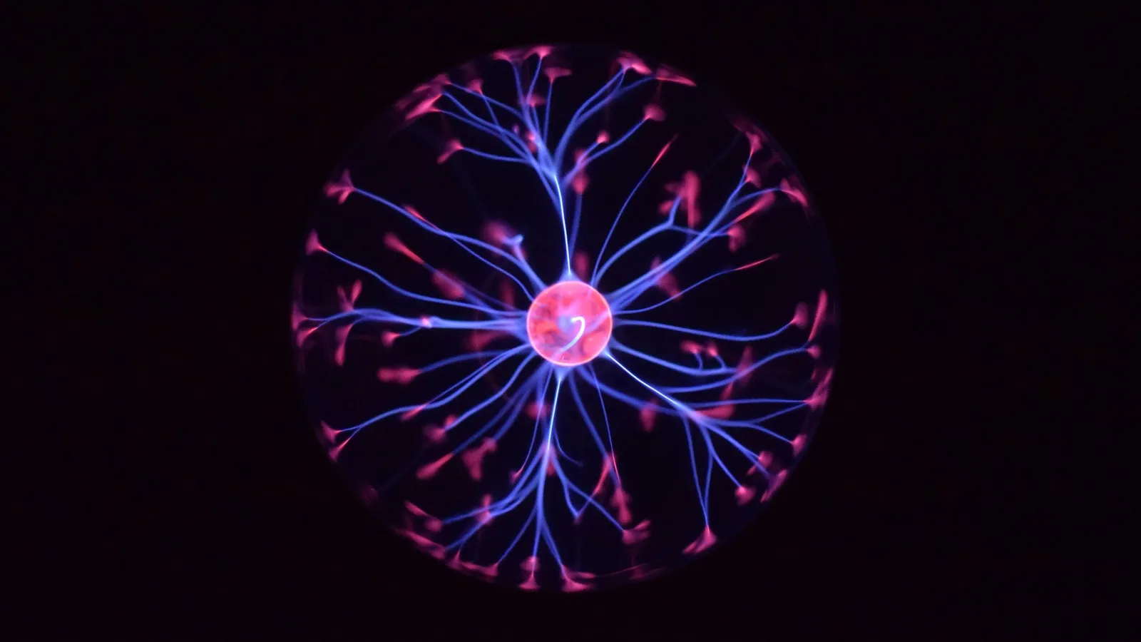 A plasma ball with glowing electric filaments