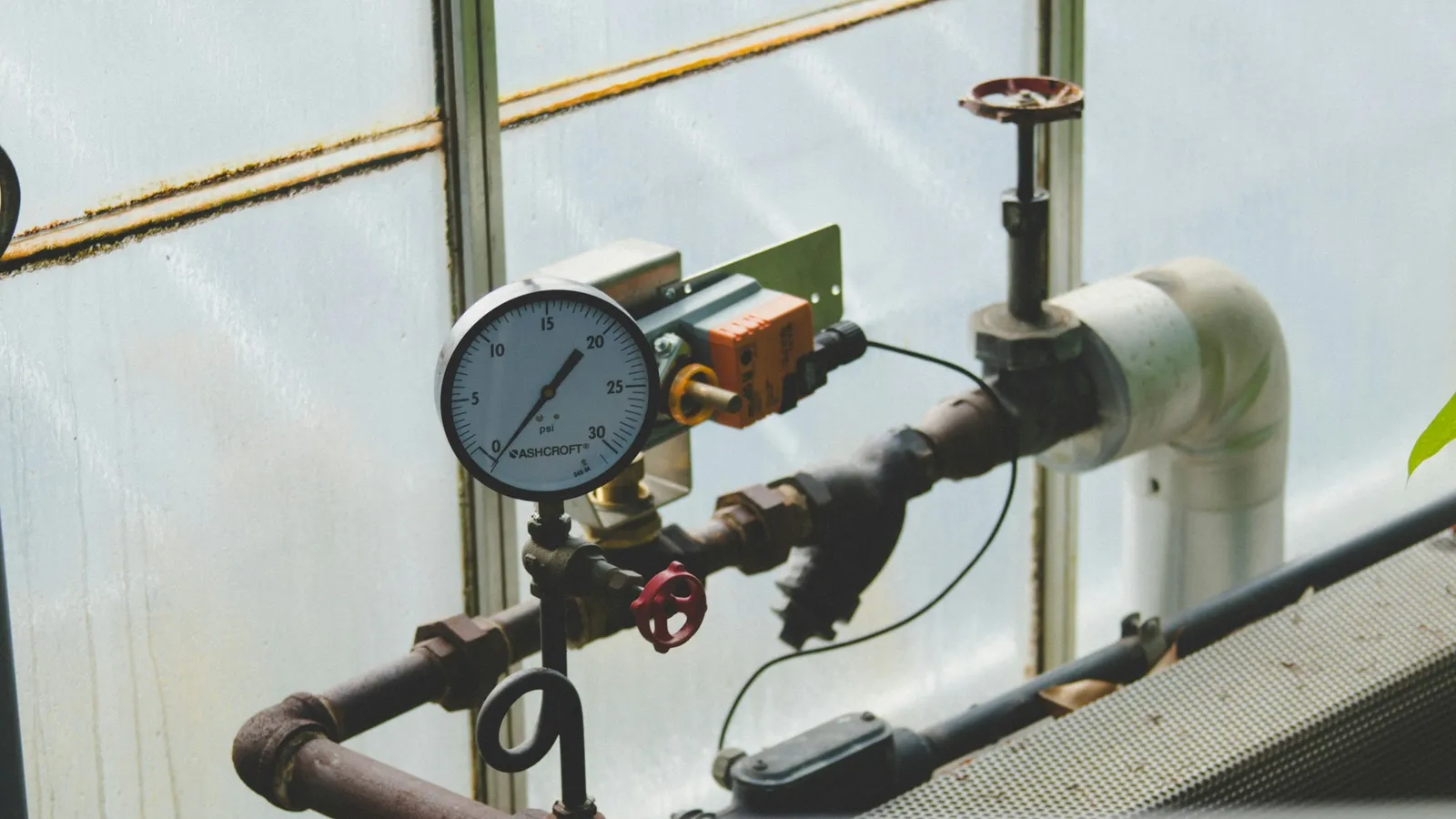 A pressure gauge fitted to a pipe