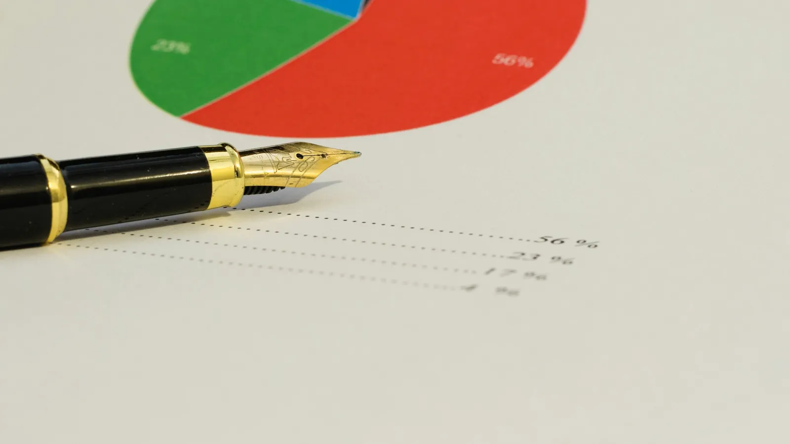 A printed pie chart beside a fountain pen