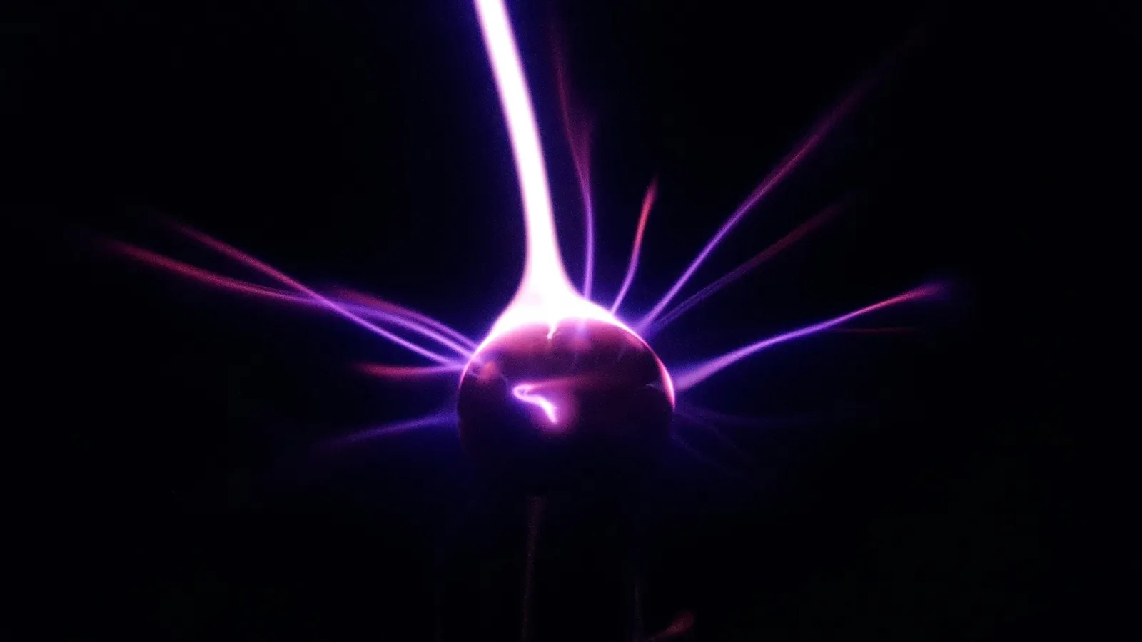 A purple electric discharge inside a plasma globe
