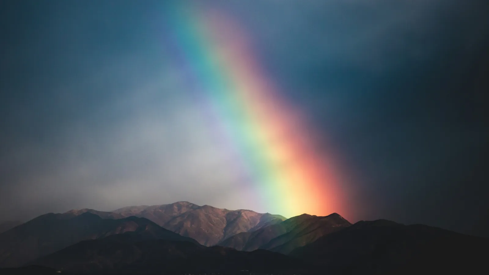 A rainbow arching over a mountain