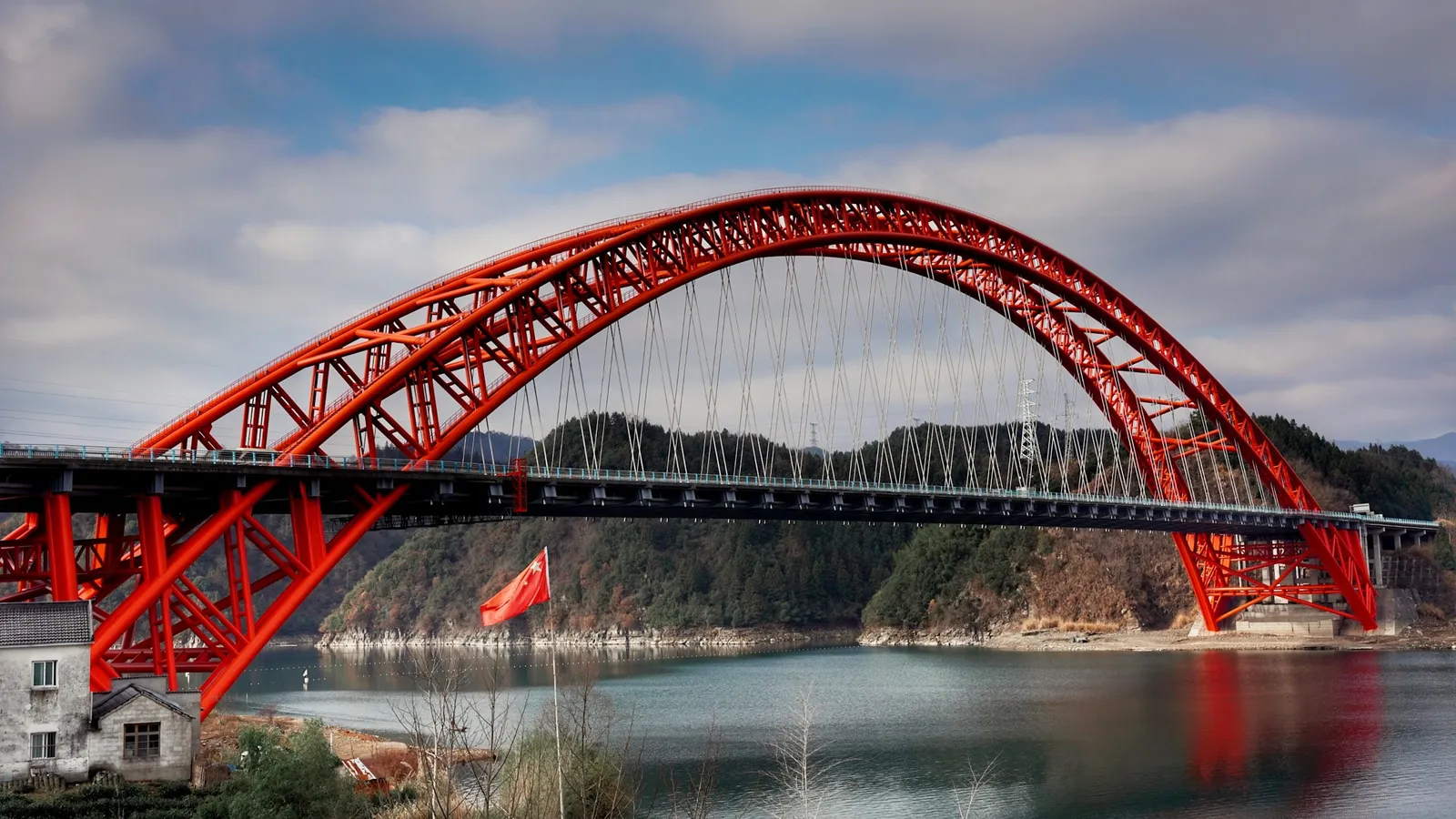 A red arched bridge above a river