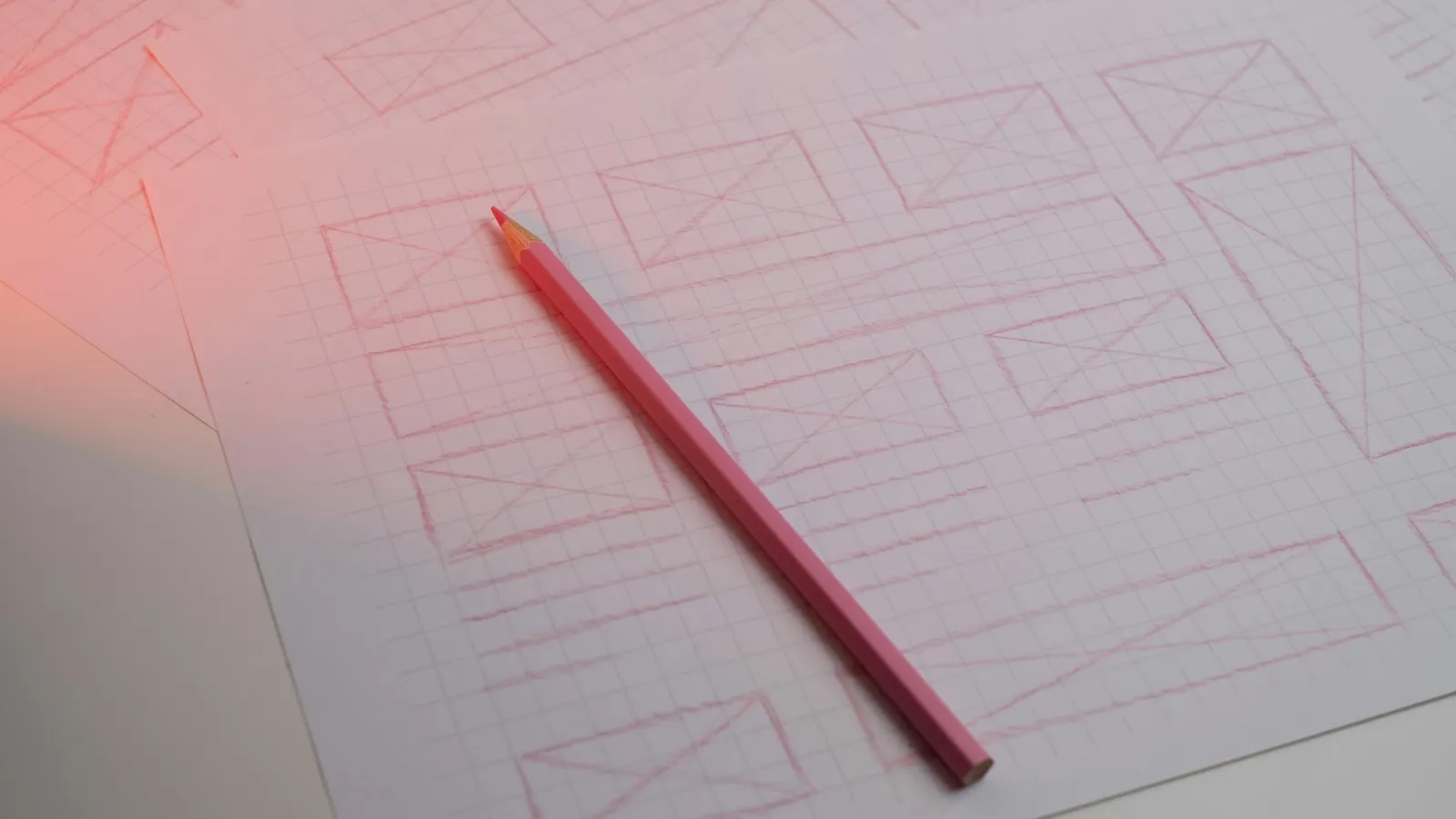 A red pencil lying on a printed form