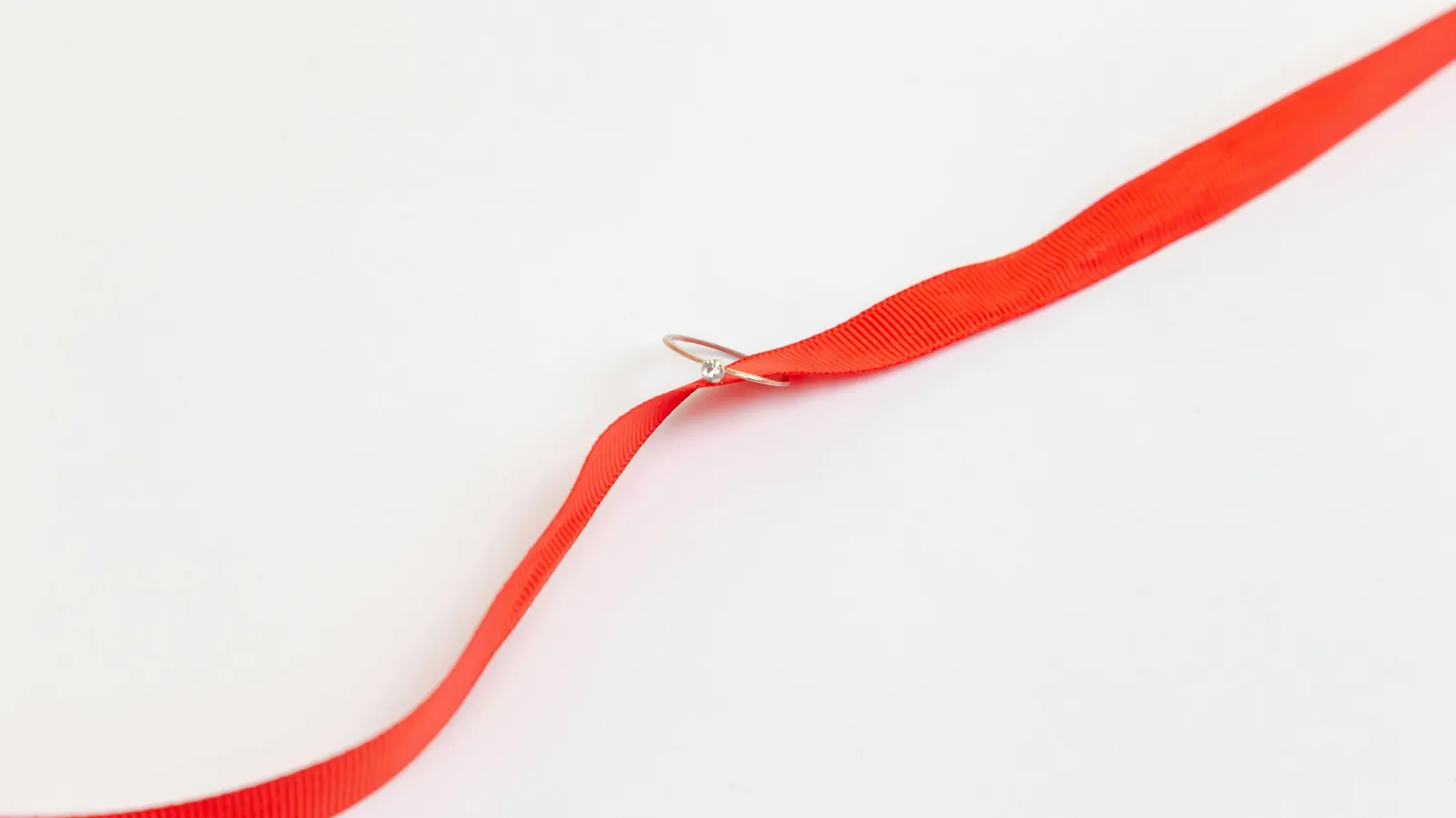 A red ribbon on a white background
