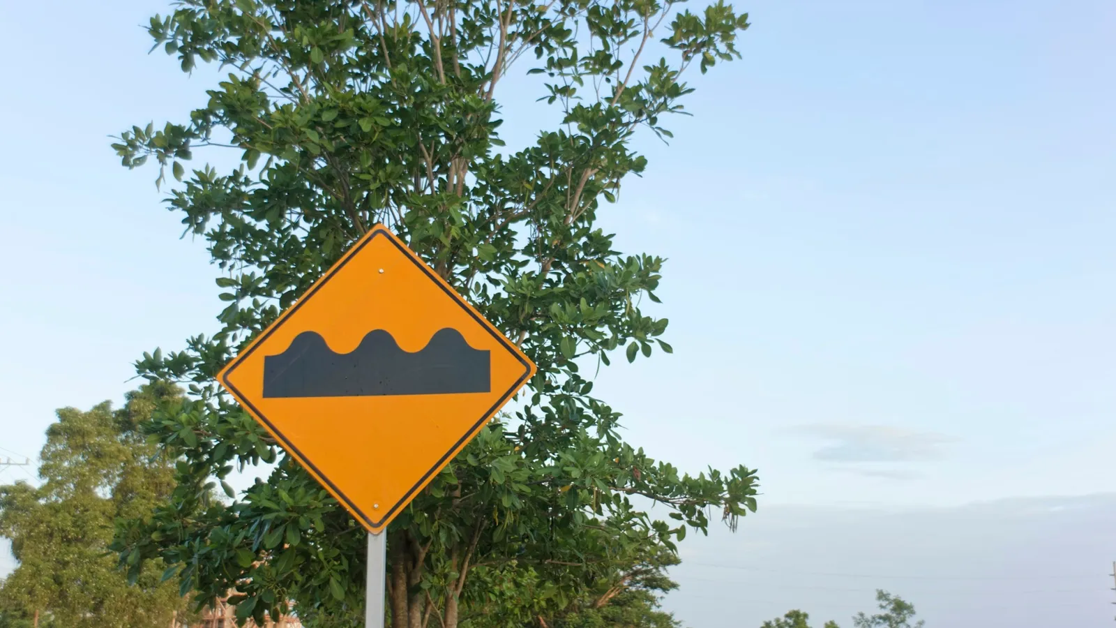 A road sign warning of a bump ahead