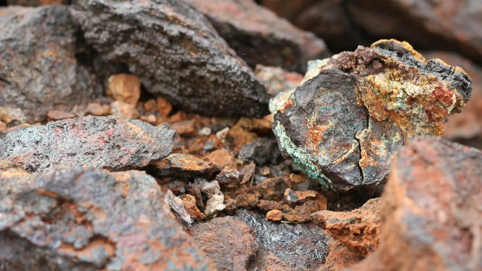 A rough chunk of metal ore among rocks