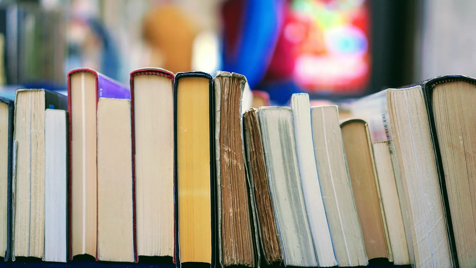 A row of books of different heights on a shelf