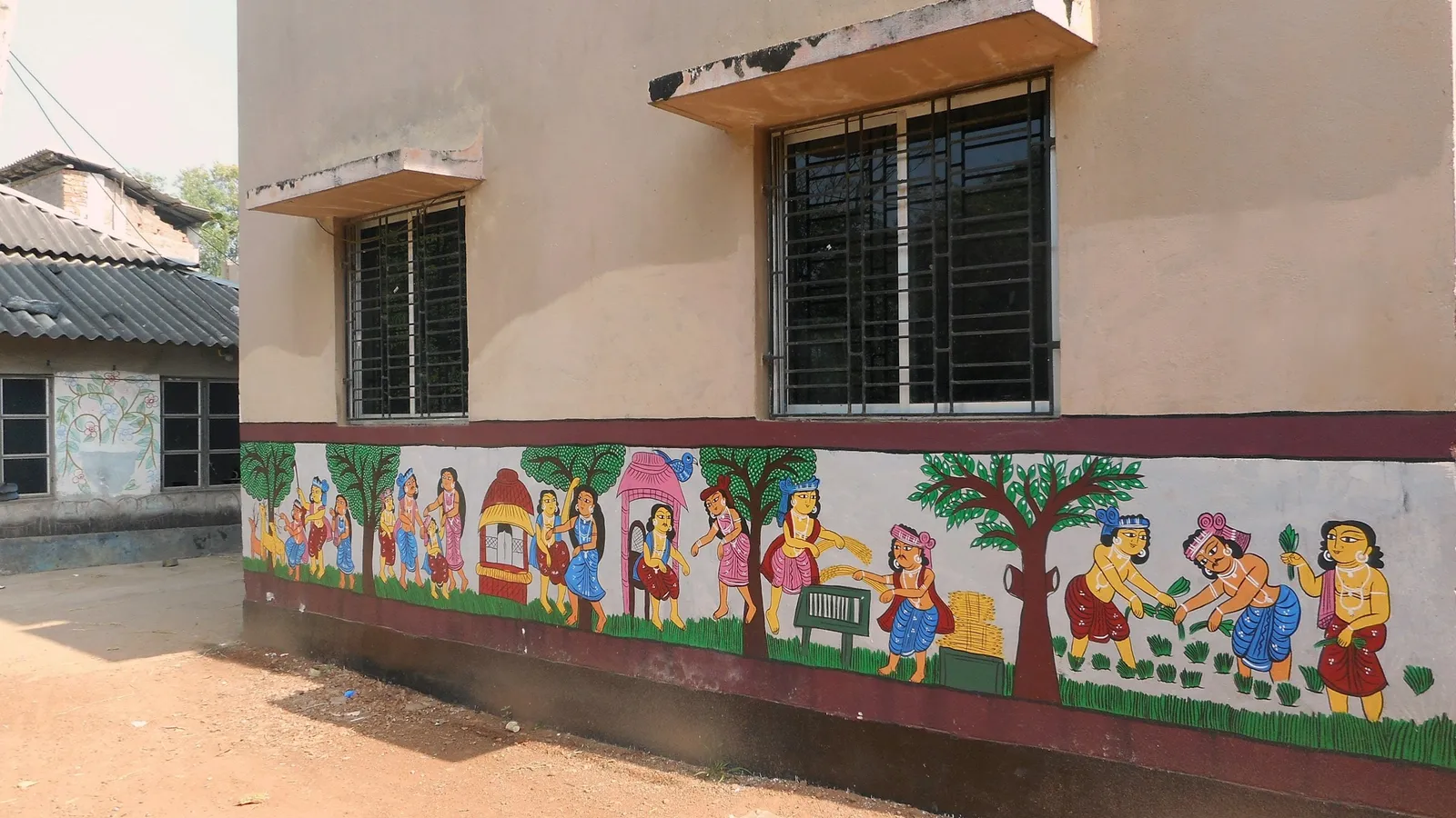 A school building with a painted mural along its wall