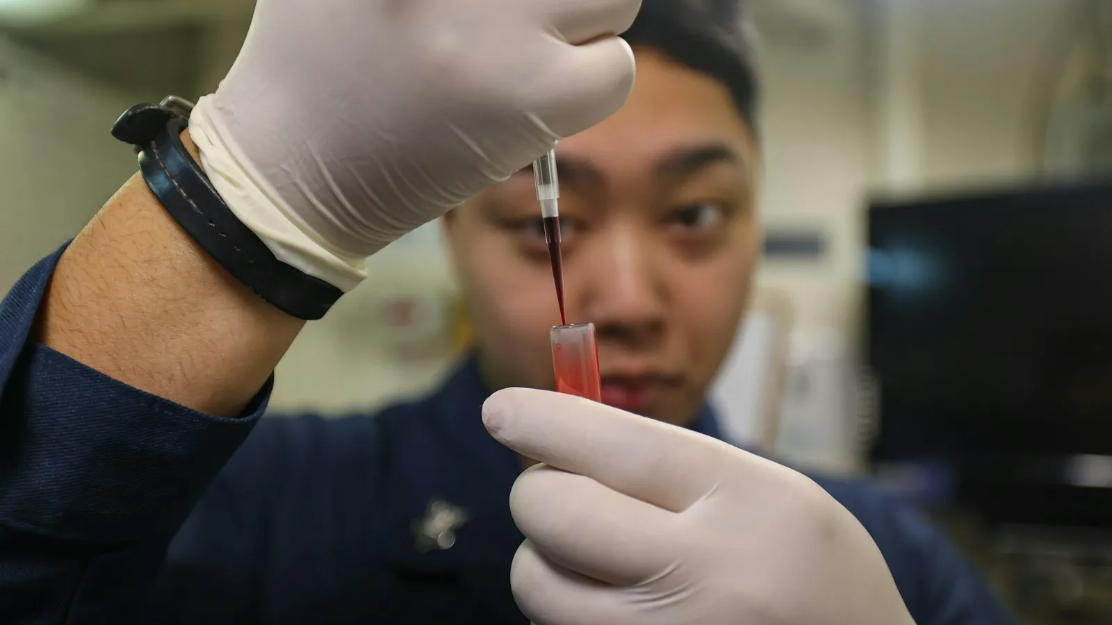 A scientist using a pipette