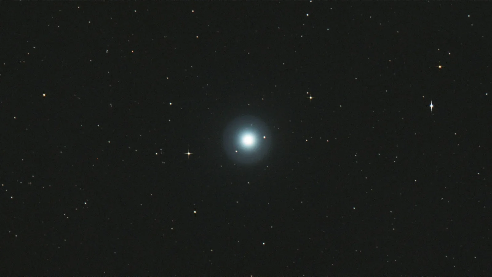A single bright star against a dark starry sky
