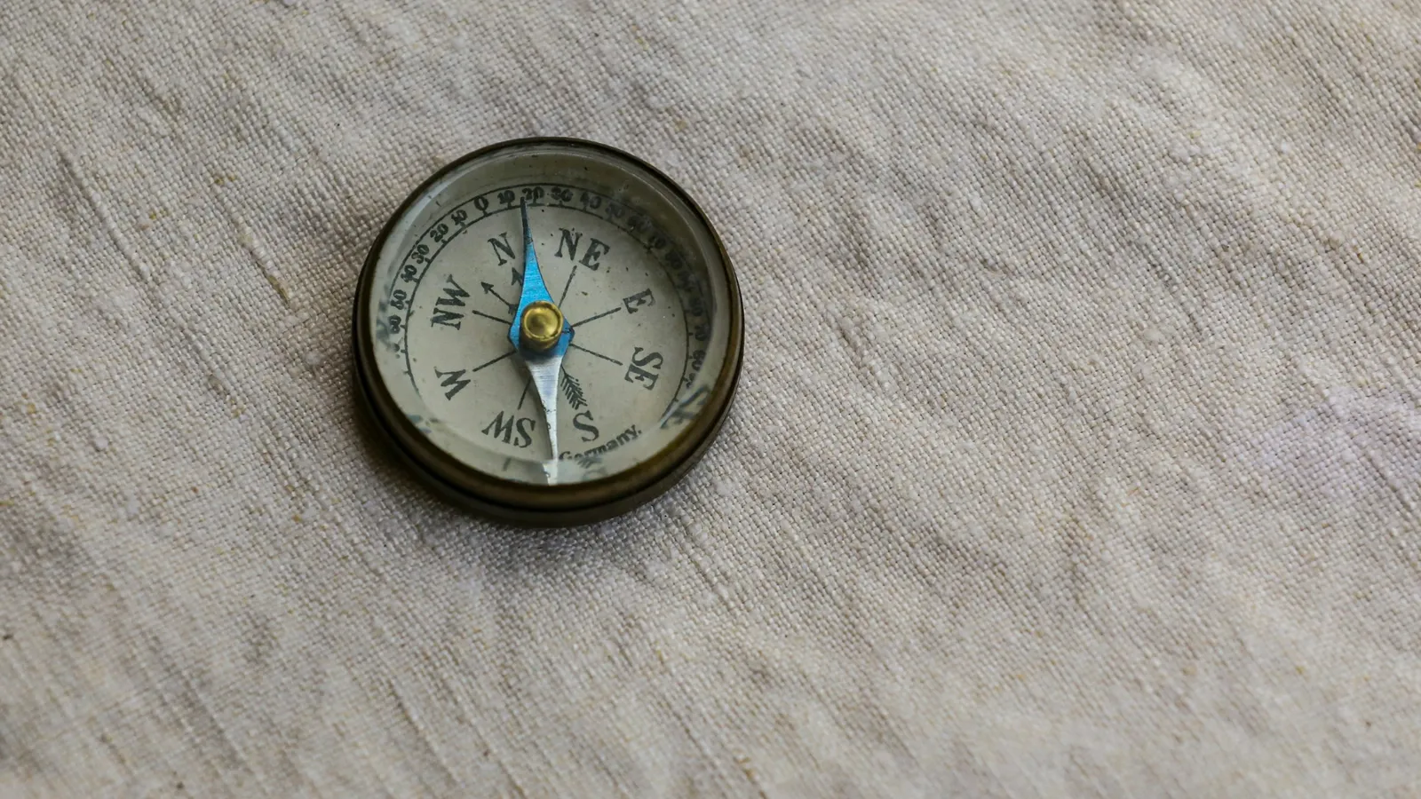 A small compass on a textured surface