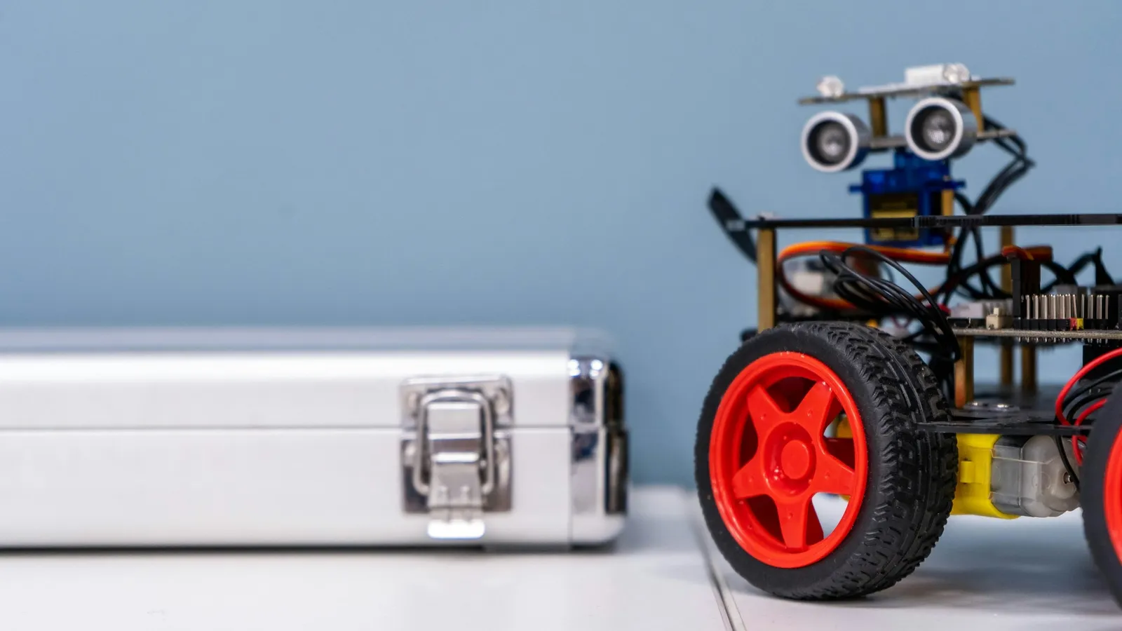 A small wheeled robot kit on a table