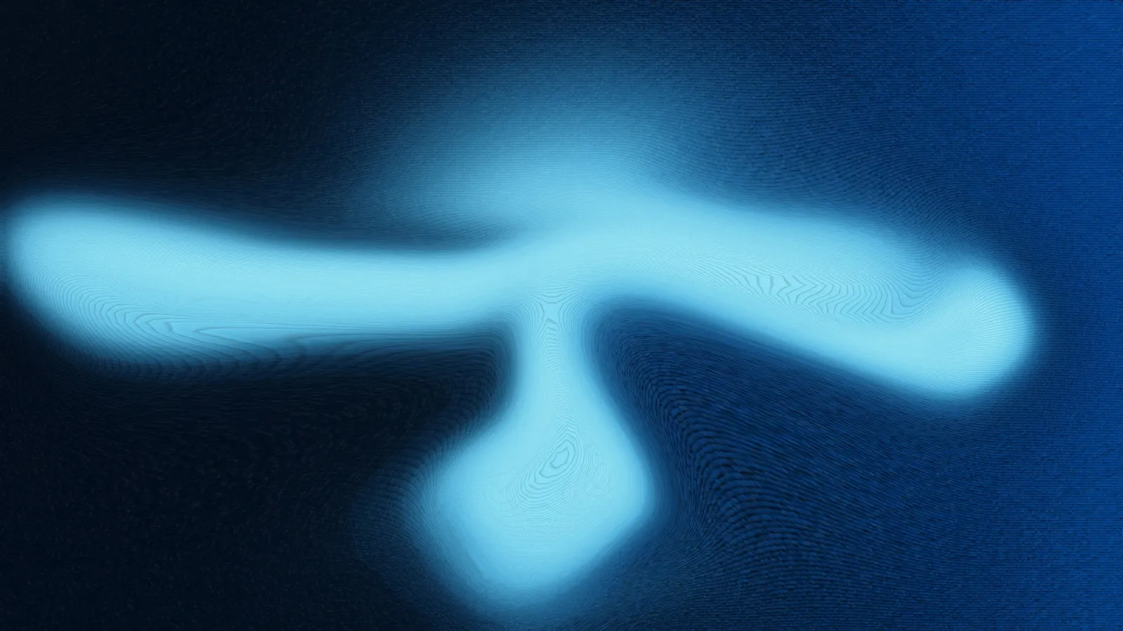 A soft blue glow of excited gas against a dark background