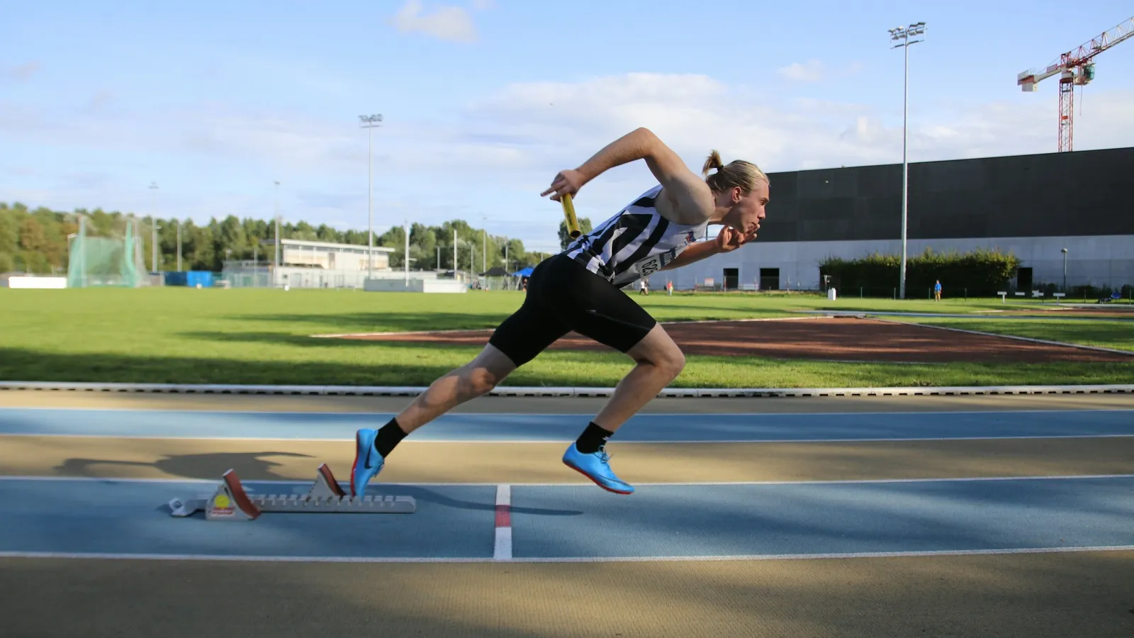 A sprinter running on an outdoor track