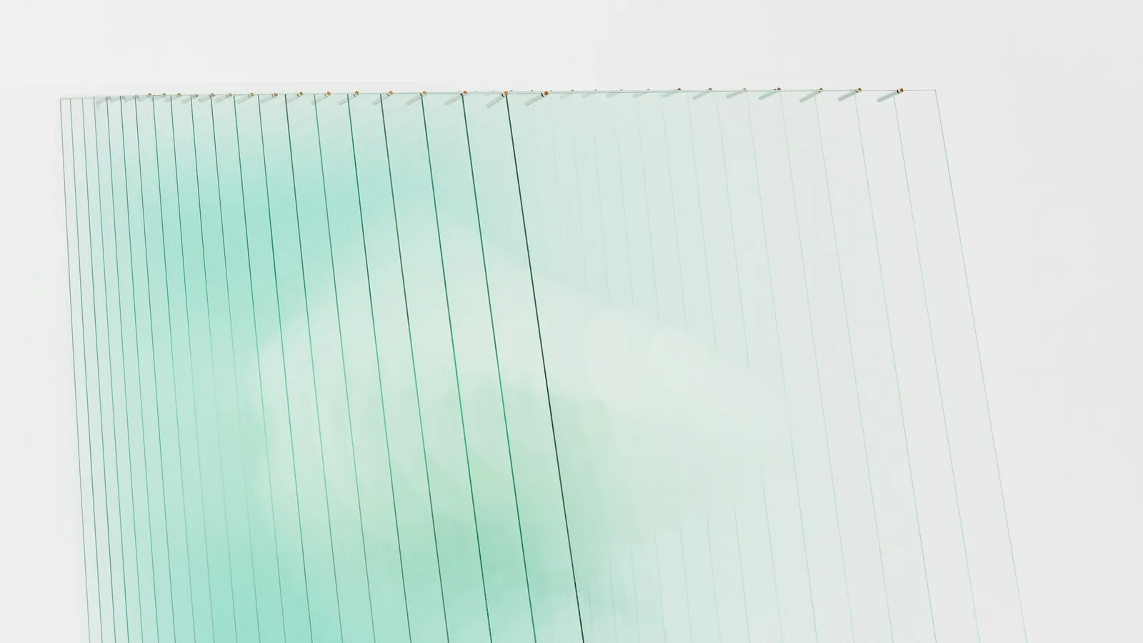 A stack of thick clear glass panes seen from the side