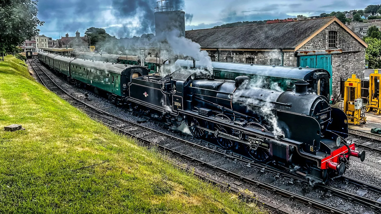 A steam train at a country station