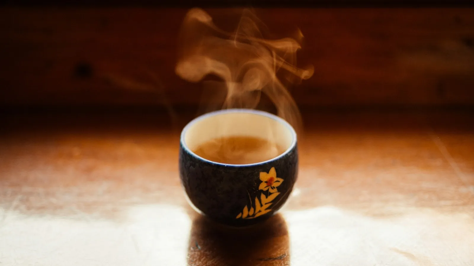 A steaming cup of tea in warm light