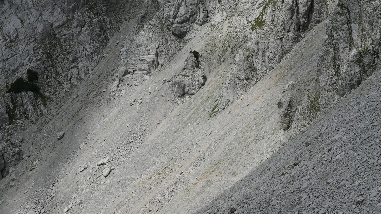 A steep slope of loose scree rock