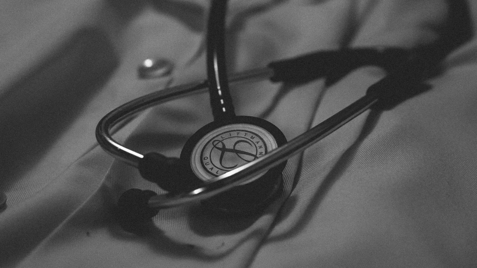 A stethoscope lying on a dark surface