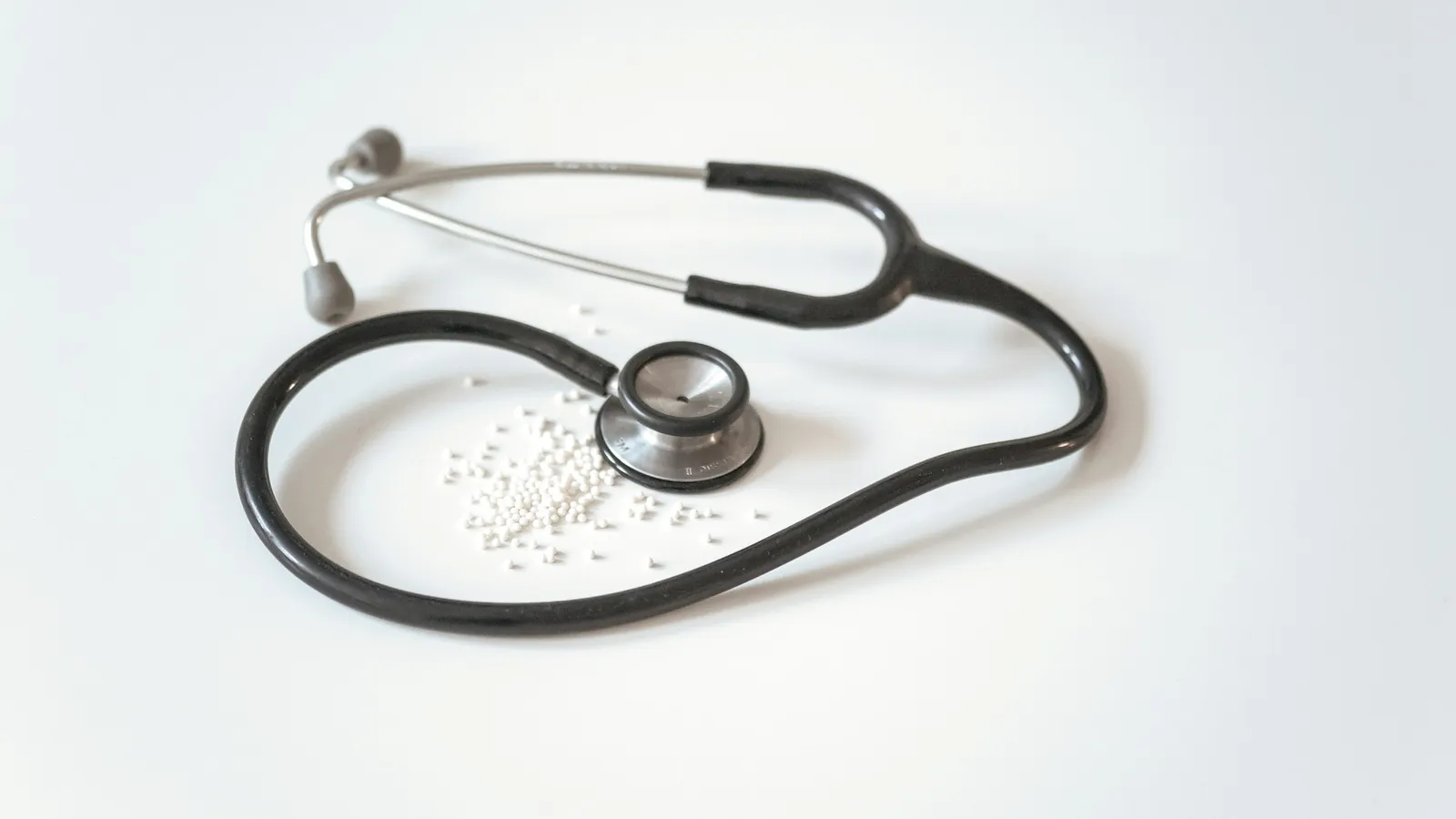 A stethoscope lying on a white surface