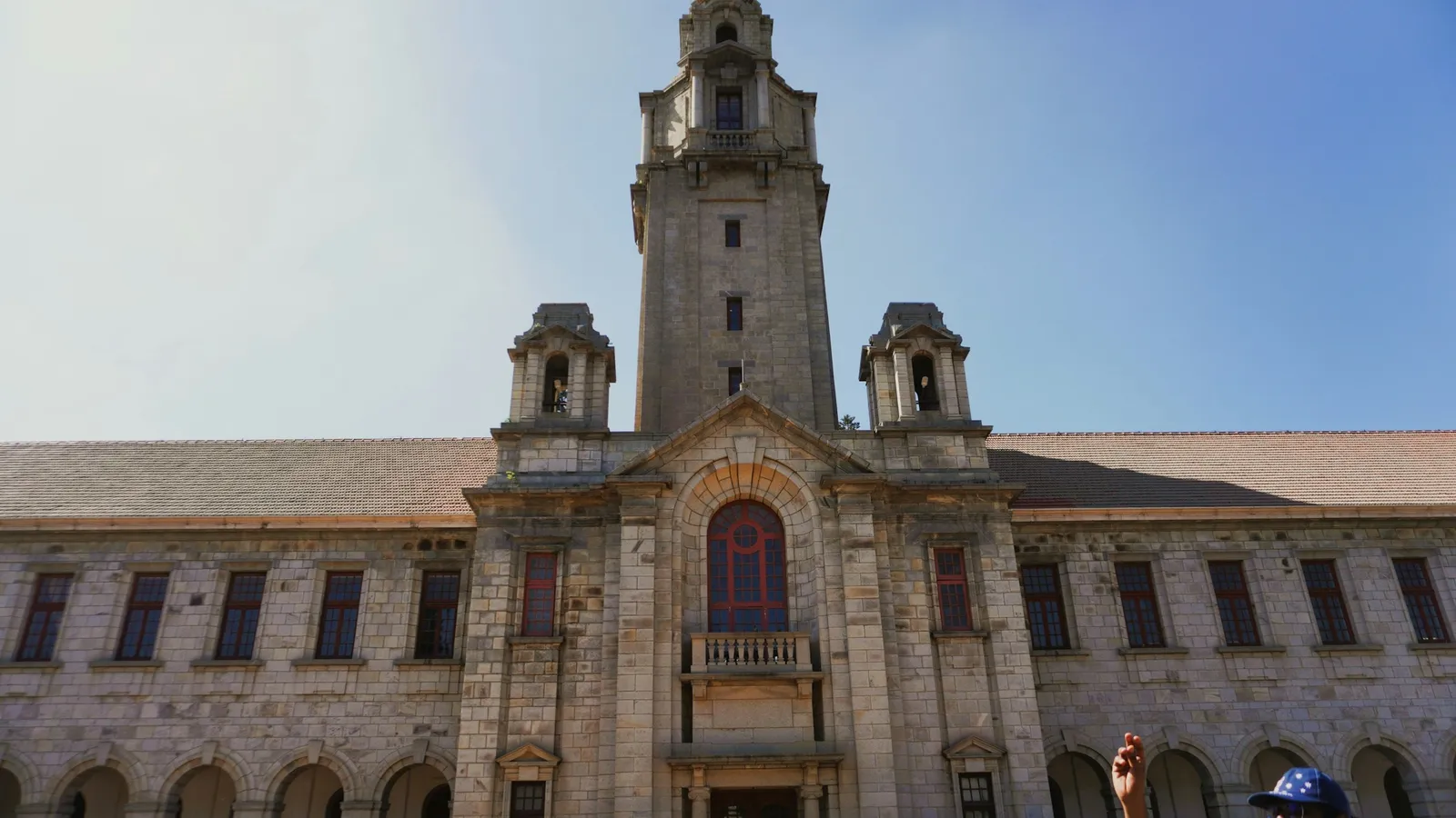 A stone institute building with a central tower in Bengaluru