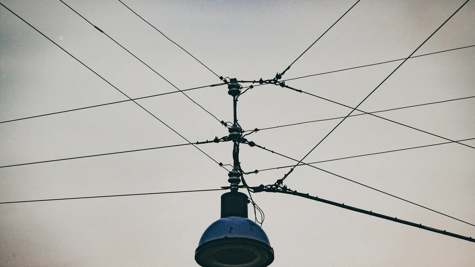 A street lamp held up by cables meeting at one point