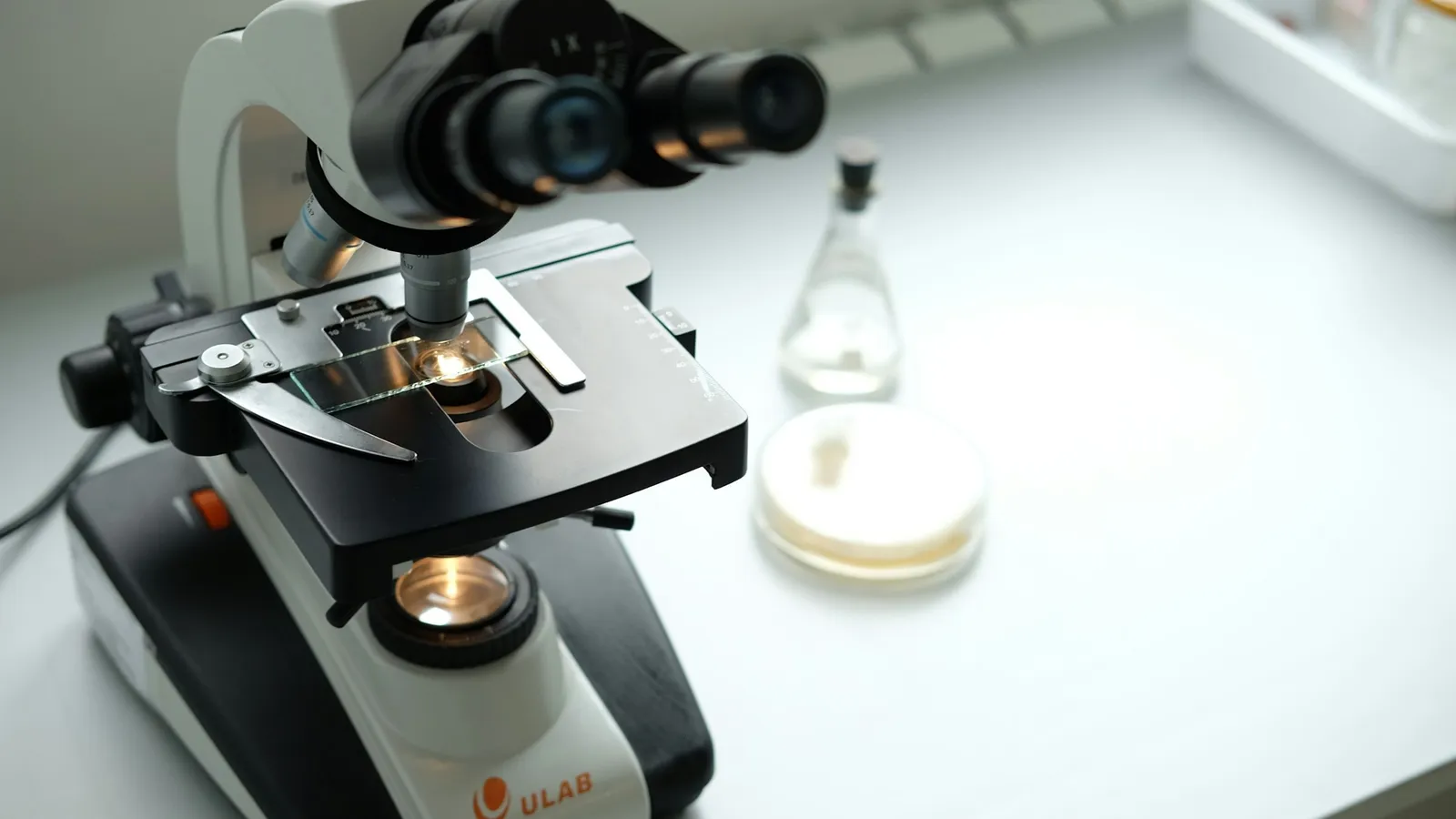 A student microscope on a white lab bench