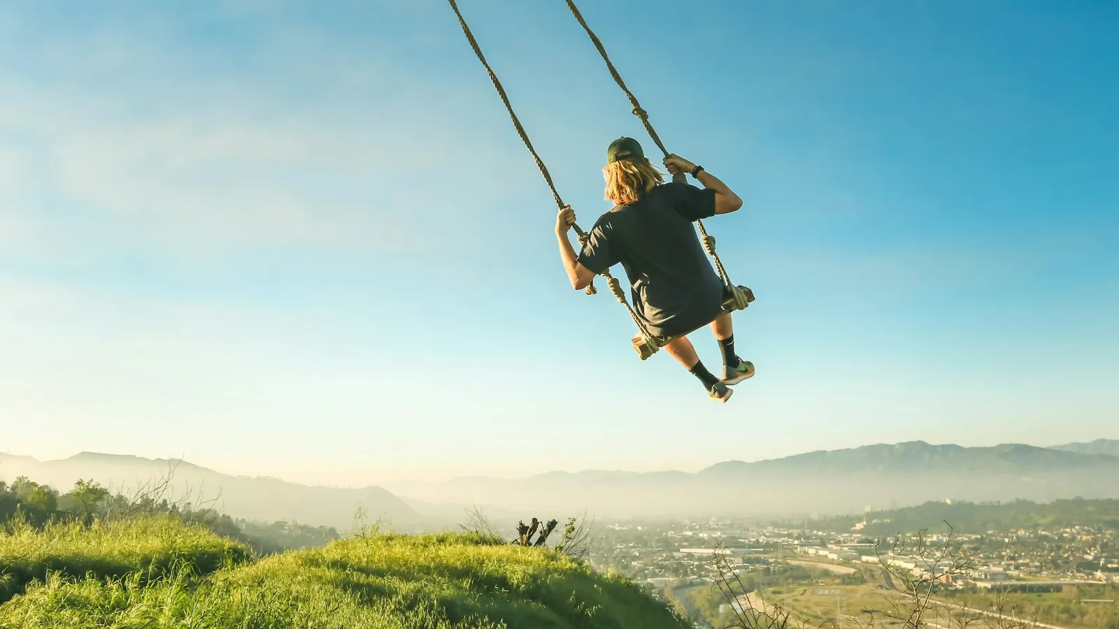 A swing over a sunny hillside