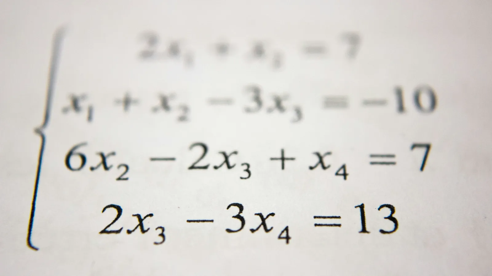 A system of linear equations printed in black ink on white paper