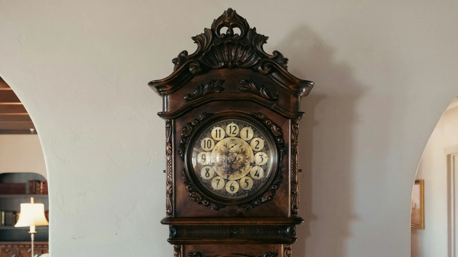 A tall pendulum clock standing in a hallway