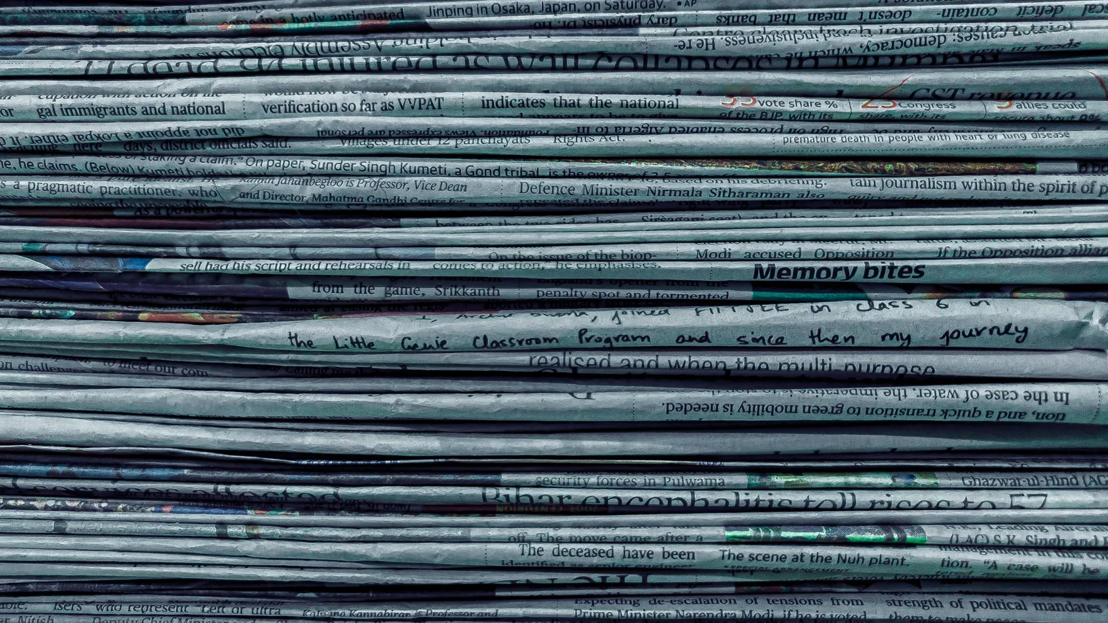 A tall stack of folded newspapers seen from the side