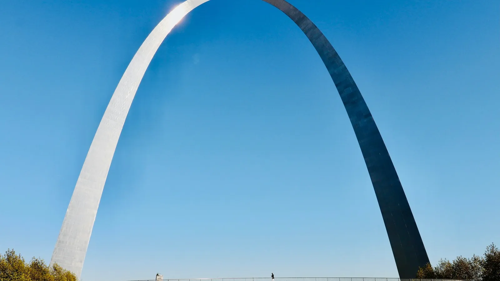 A tall steel arch against a blue sky