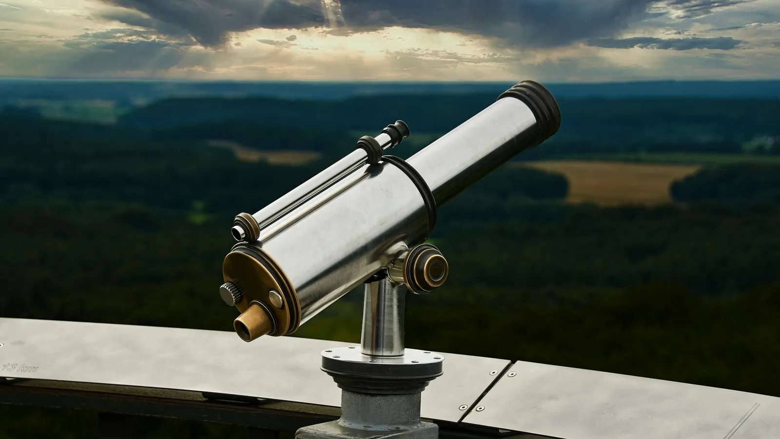 A telescope on a lookout over a wide valley