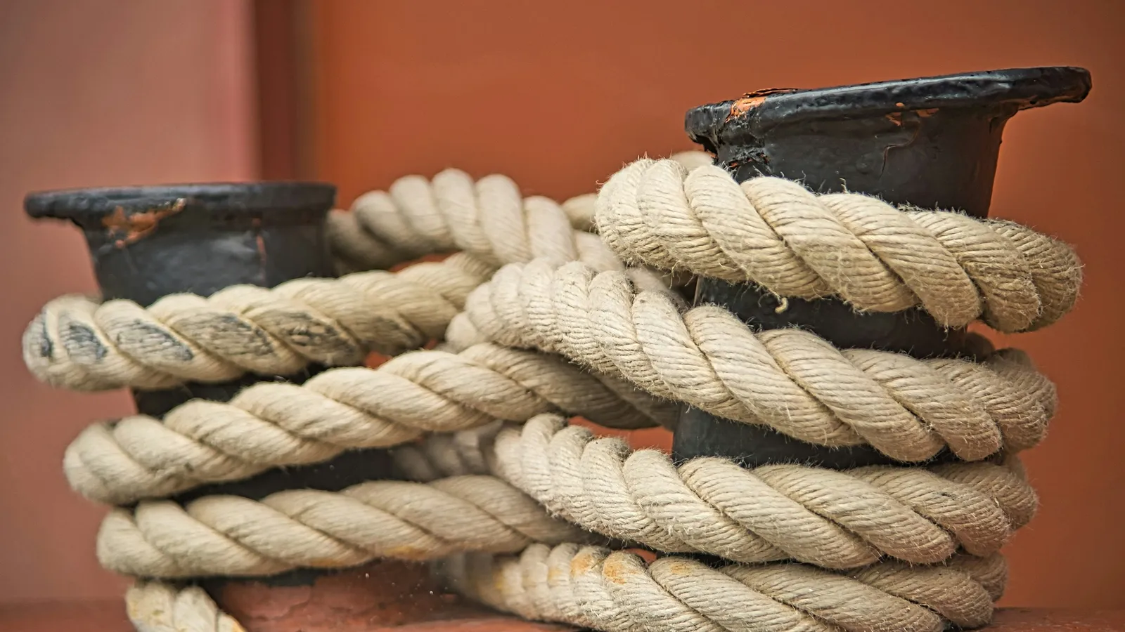 A thick coil of rope wound around a mooring post
