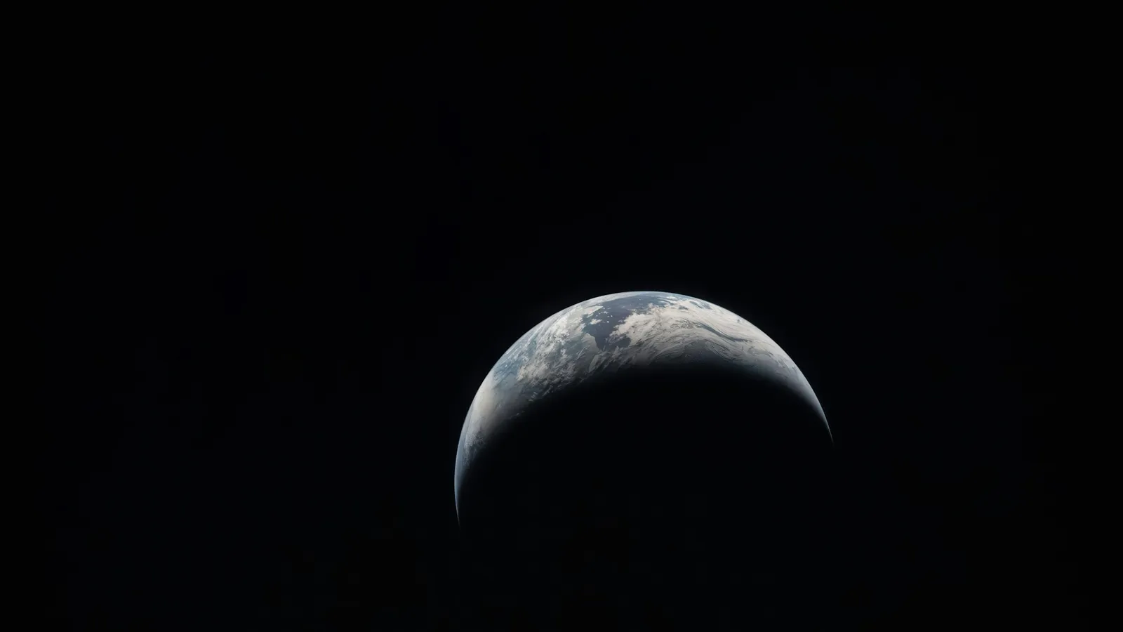 A thin crescent of a planet against black space