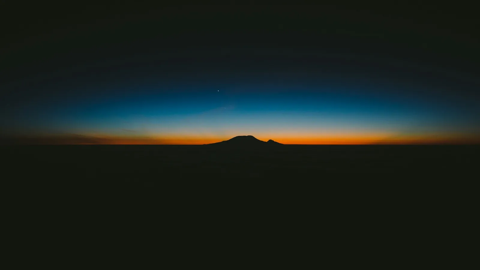 A thin glowing layer of atmosphere over the dark Earth