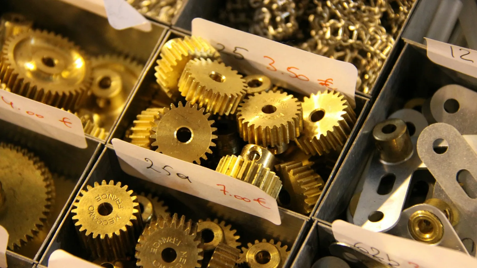 A tray of brass gear wheels in many sizes
