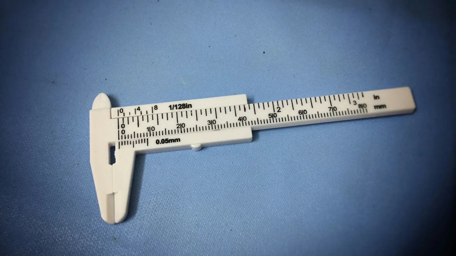 A vernier caliper on a blue cloth