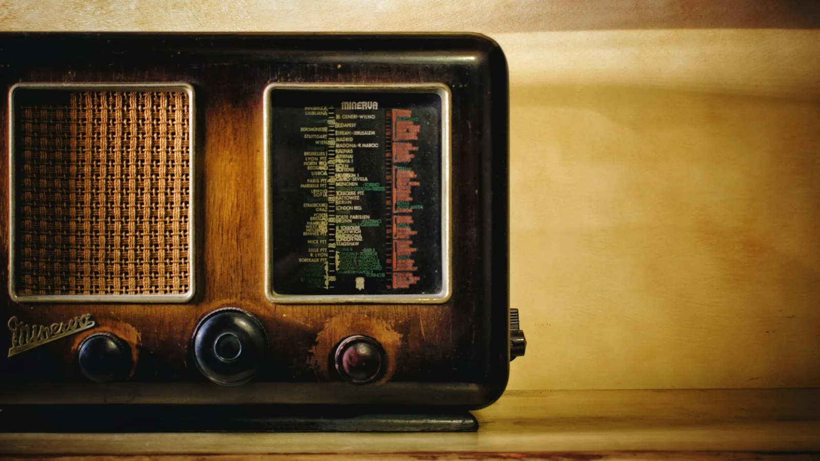 A vintage valve radio with a lit dial
