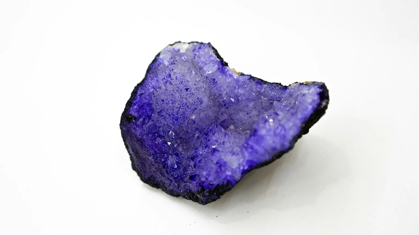 A violet crystal on a white background