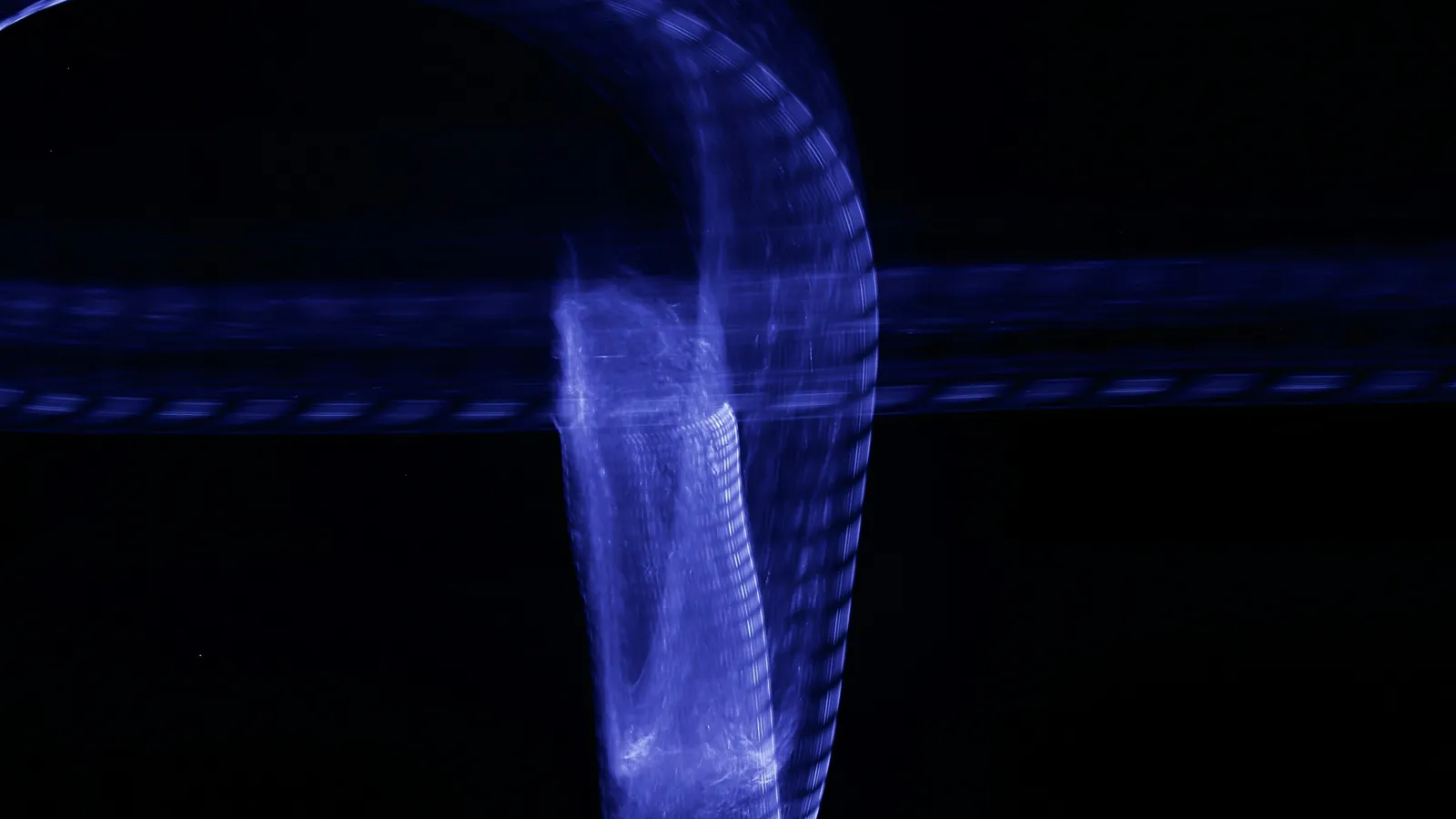 A violet streak of glowing light against black