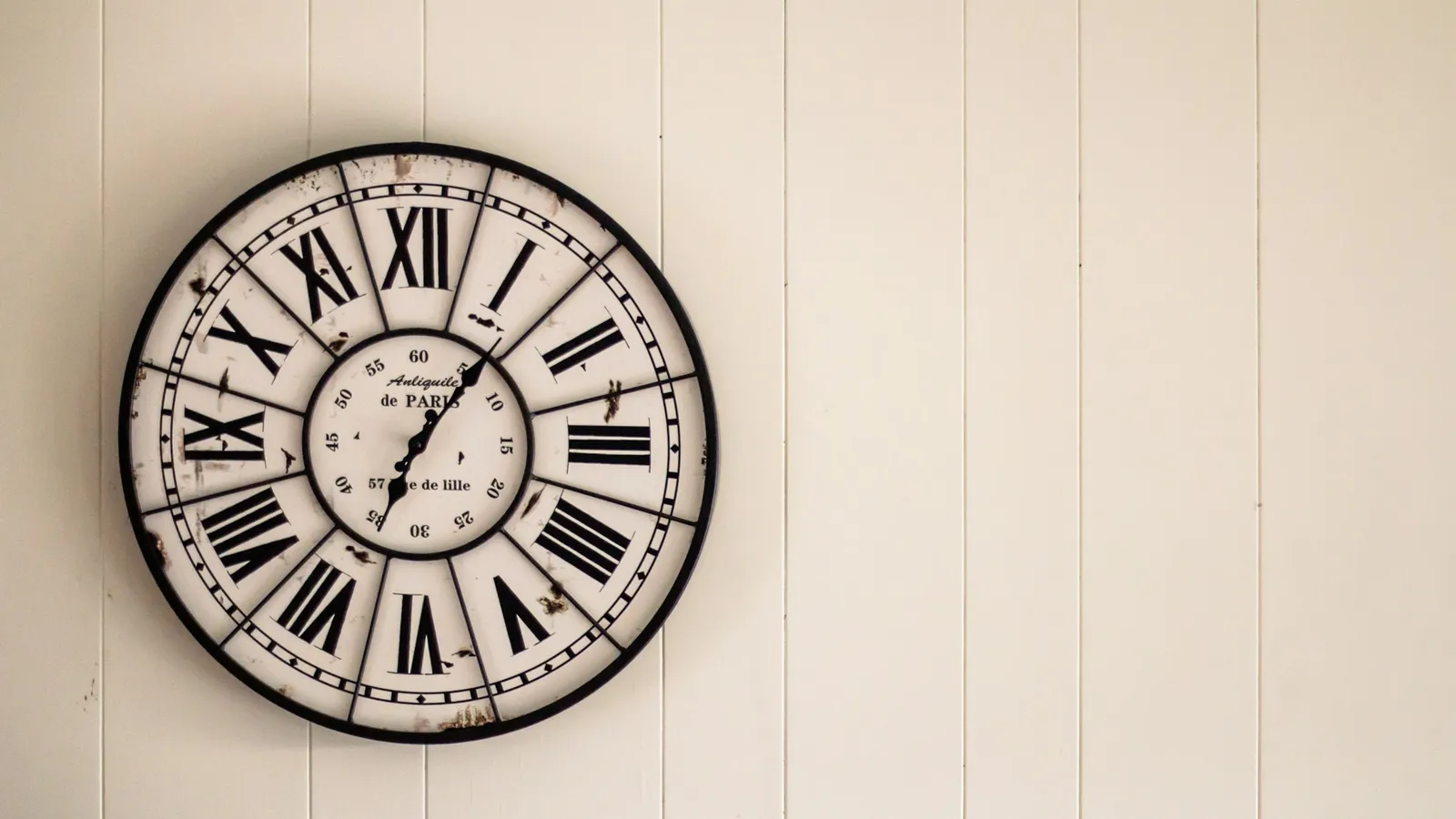 A wall clock with Roman numerals