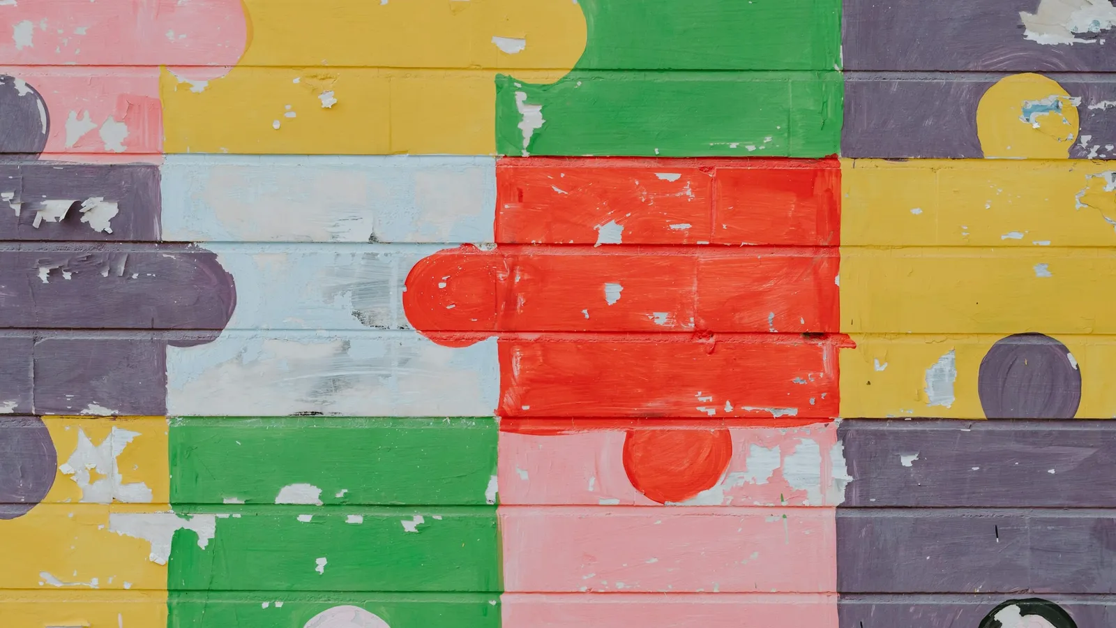 A wall of jigsaw puzzle pieces in many colours